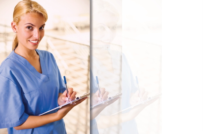 Lady in scrubs writing on a clipboard